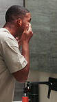 Skincare, check or black man in mirror with touch, glow inspection or examination in facial care. Wellness, hygiene or person in home with assessment, dermatology or natural cosmetics for smooth skin