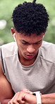 Man, running and break outdoor with smart watch, check heart rate and earphones to listen to music. Active, person and runner sweat in park with wearable tech to monitor pace, radio and fitness app.