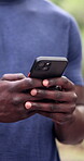 Hands, phone and typing in park with chat, comment on blog or communication forum outdoor. Person, mobile app and technology for social media post, texting or online reply with network in nature
