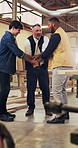 Carpenter, men or hands together with team in workshop for winning, woodwork or lumber business. Carpentry, male people or employees piling with stack or applause in celebration for timber or success