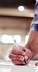 Hands, carpenter and writing in workshop with blueprint, planning or design update for accuracy. Man, woodworker and paper in manufacturing warehouse for quality assurance, project notes or precision