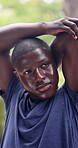 Fitness, athlete and man at park, stretching and preparing for exercise routine or physical activity. Outdoor, workout and black person with sweat, training and endurance for warm up in nature
