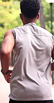 Exercise, back and man running at park for health, endurance workout and wellness benefits. Runner, cardio and person outdoor for training, fitness or practice jog for vitality with physical activity
