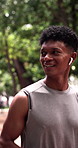 Happy, man and running in park with earphones, endurance training or listen to online music playlist. Male person, smile and runner outdoor with audio tech for podcast, cardio challenge and exercise.