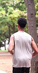 Back, man and running at park for fitness, exercise and athlete training for morning routine. People, friends and jogging in nature for sports, endurance workout and physical activity for wellness