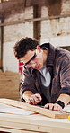 Man, woodworker and ruler in workshop with plank, measurement and design process for accuracy. Carpenter, productivity and material in warehouse for furniture manufacturing, timber and precision