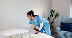Tidy, caregiver and making up bed in nursing home for maintenance, assisted living and support. Nurse, facility and woman in bedroom for cleaning, housekeeping service and change bedding for hygiene