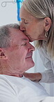 Old couple, kiss and support in hospital room, love and compassion for elderly partner with illness. Healthcare, recovery and senior woman with spouse, visit and empathy with gesture in clinic