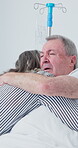 Old couple, hug and support in hospital, discussion and compassion for elderly partner with illness. Healthcare, recovery and senior people with affection, embrace and conversation with sick spouse