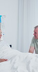 Old couple, love and support in hospital, discussion and compassion for elderly partner with illness. Healthcare, recovery and commitment for relationship, senior people and talking with sick spouse