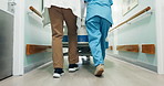 Doctor, nurse and legs in clinic with bed for treatment, surgery or operation for health. Medical staff, back and walk in hallway with teamwork, care and gurney for assessment or support in hospital