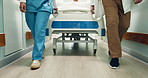Doctor, nurse and legs in hospital with bed for treatment, surgery or operation for health. Medical staff, shoes and walk in hallway with teamwork, care and gurney for assessment or support in clinic