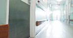 Healthcare, hospital and hallway with movement for medical care, health insurance and help in surgery. ER, emergency and lobby at clinic with corridor for wellness, service and support in medicine