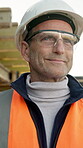 Thinking, engineer and smile with man on construction site for reflection, architect plan and vision. Property developer, perspective and remodeling idea with mature person for building inspection 