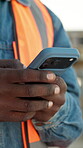 Phone, engineer and typing with hands on construction site for architect, building or feedback. Communication, contractor and project manager with person outdoor for urban development update