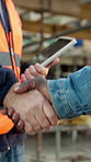 Handshake, construction site and people in team, agreement and tablet with building. Partnership, architect and shaking hands for civil engineering, technology and meeting for remodeling outdoor