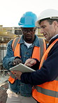Outdoor, civil engineer and men with tablet, talking or planning for property development with info. Architect, teamwork and people with technology, pointing or quality assurance on construction site