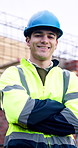 Construction site, engineer and man with arms crossed outdoor for building development with helmet. Confidence, portrait and happy architect with smile, about us or safety inspector with pride