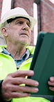 Construction, thinking or mature man with tablet, site reflection or progress report on building project. Industrial, below or engineer with tech, builder perspective or operation plan on digital app