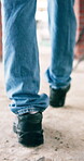 Back, legs and walking with person on construction site for inspection, job or quality control. Architecture, building and project management with engineer on worksite for property development
