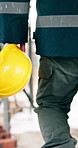 Engineer, helmet and toolbox of man walking at construction site for safety compliance, ppe and back. Person, handyman and hard hat for protocol, equipment and building development or maintenance