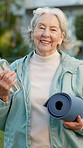 Face, senior and fitness with happy woman in nature for outdoor exercise, yoga or wellness. Portrait, elderly or female person with water bottle, smile or mat for spiritual health, zen or hydration