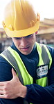 Construction, shoulder pain or man outdoor with massage, injury or labor issue in building project. Accident, ppe or engineer with joint discomfort, muscle strain or arm tension at development site.