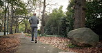 Exercise, fitness and man on road, running and endurance for physical activity or active for health. Outdoor, runner and mature person with energy for cardio, back and workout for wellness in city