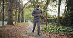 Fitness, practice and man on road, running and endurance for physical activity or active for health. Outdoor, runner and mature person with energy for cardio, serious and workout for wellness in city