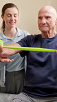 Physiotherapy, resistance band and health with old man in clinic for consulting, stretching or fitness. Orthopedic, physical therapy and healing with patient in office for rehabilitation or support