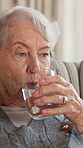 Relax, thinking and water with senior woman in apartment for health, hydration or refreshment. Break, drink and minerals with old person on sofa in retirement home for calm, reflection or wellness