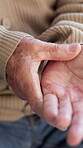 Hands, old man and joint pain in home with arthritis, carpal tunnel and osteoporosis or injury. Massage, inflammation and ache or hurt with senior person and wrinkled skin or chronic disease