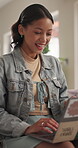 Freelancer, home and woman with laptop, laughing or video editing project on website in living room. Creative, remote work and happy person with technology, post production and funny reel in house