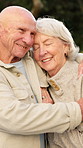 Hug, happy and senior couple in nature with love, relationship support or retirement security. Smile, elderly people and outdoor with connection for trust, affection or loyalty in marriage commitment