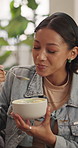 Smile, woman and eating at house with dessert, sweet treat and reunion for bonding together. Friends, laugh and ice cream in home with comfort snack, frozen dairy and playful moment for weekend visit