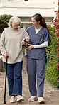 Senior, woman and walking stick with nurse in outdoor garden for mobility, exercise or support together. Elderly, female person or caregiver helping patient with cane for assisted living or balance