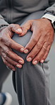 Fitness, hands and stretching knee outdoor for wellness, workout preparation and injury prevention. Person, runner and warm up muscle, legs and getting ready to start exercise to improve flexibility
