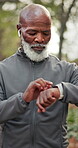 Black man, senior and smart watch with fitness outdoor, monitor health or wellness app with music. Retired, timer or stopwatch with runner in park for exercise, tech and audio with training progress