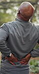 Back pain, fitness and inflammation with black man outdoor for cardio training or workout. Behind, injury and spine with mature runner in park for exercise or symptoms of arthritis and fibromyalgia