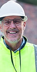 Happy, man and face on construction site for confidence, management and property development. Pride, portrait and mature civil engineer with inspection for maintenance safety, repairs or renovation