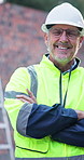 Happy, man and face on construction site with arms crossed, management or property development. Pride, portrait and mature civil engineer with inspection for maintenance safety, repairs or renovation