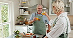 Cheers, cooking and senior couple in home kitchen with juice, bonding or love in marriage. Happy, food and toast for health and people with celebration, anniversary or drink in house for retirement