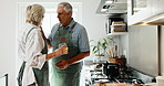 Taste, cooking and senior couple by stove in home kitchen with wooden spoon, bonding and love. Happy, food and feeding for sauce and flavour with approval, people and teamwork in house for retirement