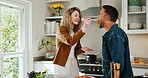 Feeding, food and happy couple in kitchen together for bonding, culinary hobby or relationship. Cooking, love and taste with people in apartment for healthy eating, meal testing or satisfaction