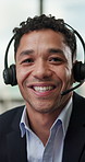 Face, headset and smile with man in call center for assistance, feedback or problem solving. Happy, microphone and typing with business person in office with customer service or technical support