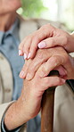 Cane, care and hands of old person with nurse in retirement home for assisted living support. Comfort, conversation and walking stick of senior patient in apartment with caregiver for healthcare
