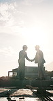 Construction, handshake and people at site for meeting, agreement and project approval for building. Contractor, real estate and men shaking hands for remodeling, renovation and property development