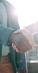 Construction, hands and people outdoor with handshake, agreement or building approval for renovation. Contractor, real estate and men with property deal for development, remodeling and architecture