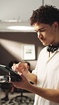 Man, production and assistant with tablet in filming industry for radio control or role management. Male person, crew member or checking signal with technology for preparation in recording studio