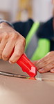Hand, supply chain and man with box cutter in warehouse for unboxing, quality control and inspection. Shipping, worker and open package to process return, order fulfillment and inventory logistics